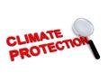 Climate protection with magnifying glass on white