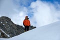 Climber alpinist stands on the top of the mountain. Snowy peaks and sky, Altai, Belukha