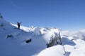 Climber or alpinist at the top of a mountain. A success of mountaineer reaching the summit. Outdoor adventure sports in winter