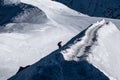 Climber ascending arete in way up to Aiguille du Midi with Vallee Blanche in the background