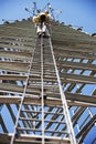 Climber ascending cell phone tower Royalty Free Stock Photo