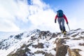 A climber ascending a snow covered ridge