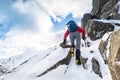 A climber ascending a snow covered ridge