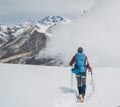 Climber with backpack and trekking poles descending Mera peak high slopes at cca 6000m enjoying legendary Mount Everest, Nuptse, Royalty Free Stock Photo