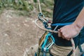 Climber belaying with figure eight.