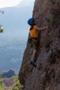 climber boy. the child trains in rock climbing. cute teen kid climbing on rock with insurance, lifestyle sport people concept Royalty Free Stock Photo