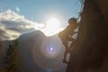 climber boy. the child trains in rock climbing. cute teen kid climbing on rock with insurance, lifestyle sport people concept Royalty Free Stock Photo