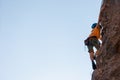 climber boy. the child trains in rock climbing. cute teen kid climbing on rock with insurance, lifestyle sport people concept Royalty Free Stock Photo