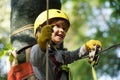 Climber child on training. Cute little boy in climbing safety equipment in a tree house or in a rope park climbs the