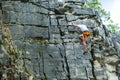 Climber climbing on top of a mountain with a safety