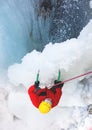The climber climbs on ice near the waterfall. Royalty Free Stock Photo