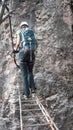 Climber crossing a pending bridge