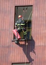 Climber firefighter go in the house by window