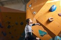Climber gets ready to bouldering competition among people with physical disabilities