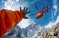 Climber greetings Medical Rescue helicopter landing in high altitude Himalayas mountains during mount expedition climbing. Travel Royalty Free Stock Photo