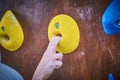 Climber hand on the bouldering climbing wall round grip Royalty Free Stock Photo