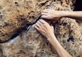 Climber hands climbing on cliff edge
