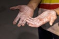 Climber hands lubricates magnesium powder before starting training