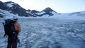 Mountain climber looking out onto a large glacier in the Silvretta mountains in Switzerland