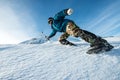 Climber with an ice ax climb on the snowy mountain.