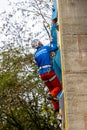 Climber with ice axes climbing on artificial climbing drytooling wall on the Drytool World Cup in Brno Royalty Free Stock Photo