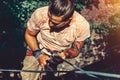 Climber Man Hanging On A Rock On A Rope And Looks Somewhere On The Wall. Extreme Lifestyle Outdoor Activity Concept Royalty Free Stock Photo