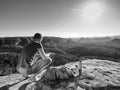 Climber man sit on rock, prepare for eating snack during rest