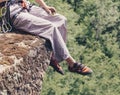 Climber man sitting on edge of cliff.