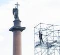 A climber on a metal structure near the Alexandrian Pillar