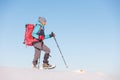 Climber in the mountains. A girl with a backpack and snowshoes walks through the snow Royalty Free Stock Photo