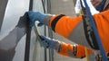 Climber washes windows on a high-rise building. Royalty Free Stock Photo