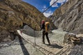 Climber passing a bridge from the deep valleys of the Karakoram Mountains