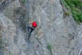 Climber placing safety nets to avoid falling rocks