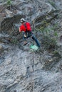 Climber placing safety nets to avoid falling rocks