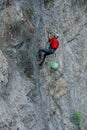 Climber placing safety nets to avoid falling rocks