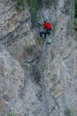 Climber placing safety nets to avoid falling rocks