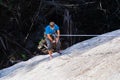 Climber rappelling after climbing a rock wall Royalty Free Stock Photo