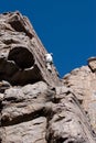 Climber reaching top of climb