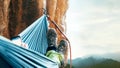 Climber resting in hammock on the vertical cliff wall Royalty Free Stock Photo