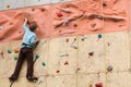 Climber rises to the climbing wall. Royalty Free Stock Photo