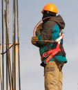 Climber with safety belt and helmet at the reconstruction area