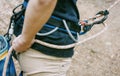 Climber belaying with rope and figure eight outdoor.