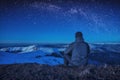 A climber sitting on a ground at night