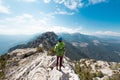 climber stands on top of the mountain. girl climber in a helmet and with a backpack mountains. Turkey