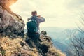 Climber take a mountain landscape photo on his smartphone Royalty Free Stock Photo