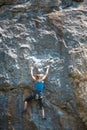 The climber is training to climb the rock.