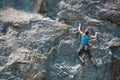 The climber is training to climb the rock.