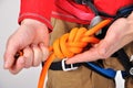 Climber tying double bowline knot