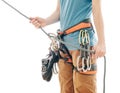 Climber woman in safety harness belaying with rope and figure eight.