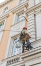 Climber worker renovating the facade of a building. Budapest, Hungary.